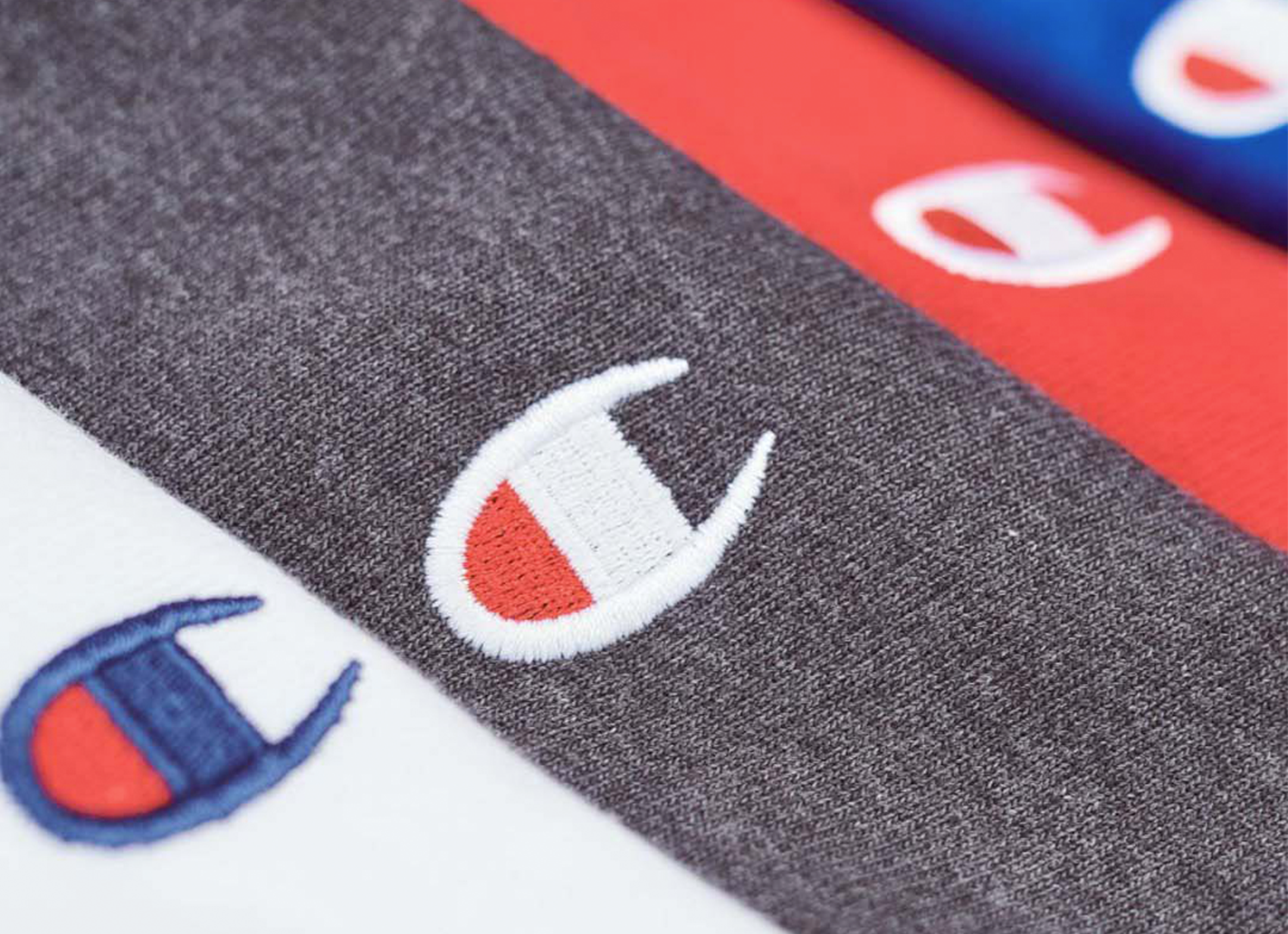 Close-up of Champion logo on various sweatshirts